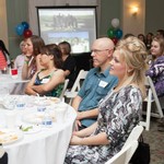 People sitting at round take watching a presentation